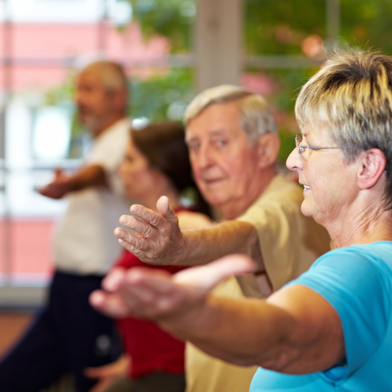 senior-woman-in-group-doing-aerobics-in-a-gym